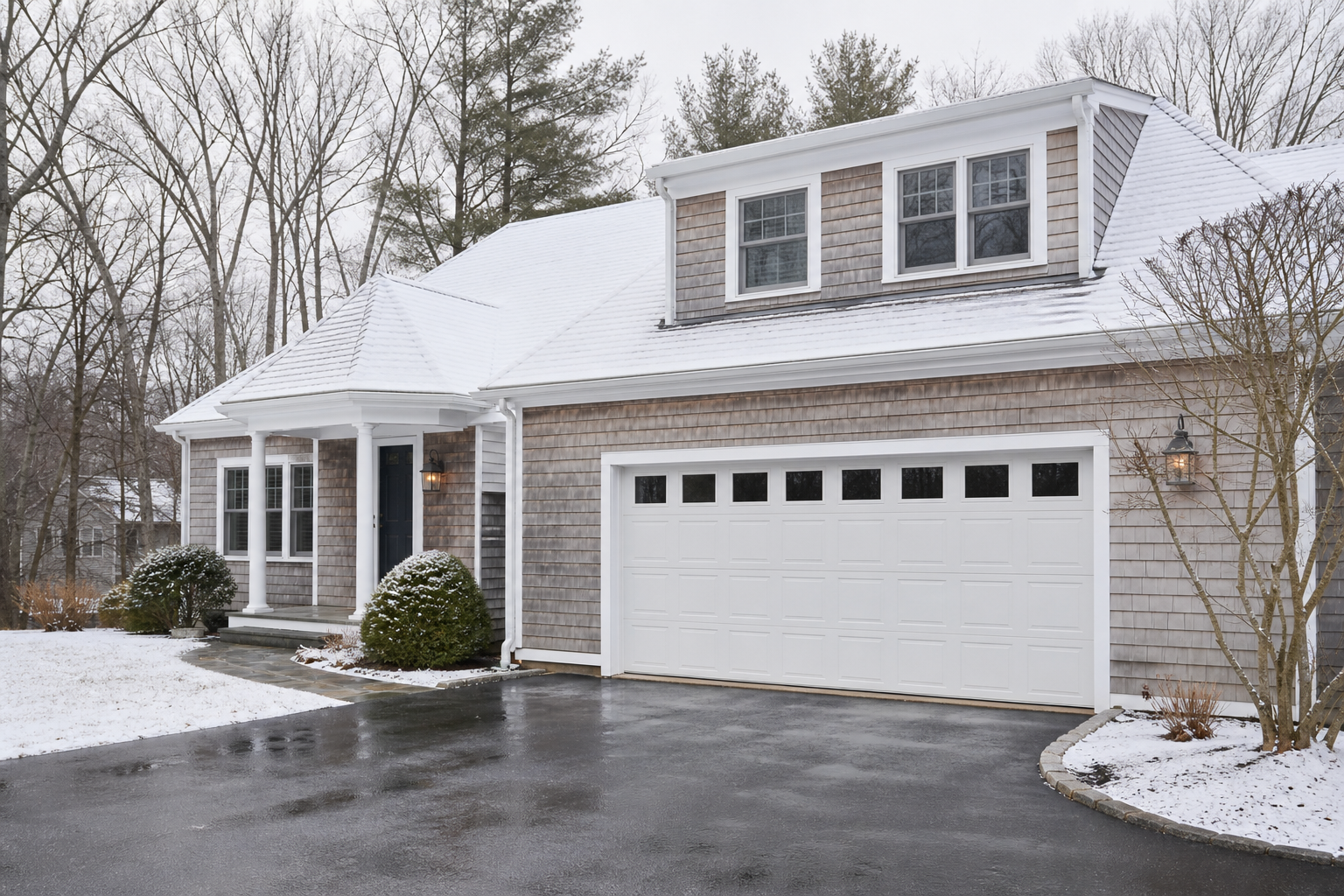 Suburban Hingham home with a visible garage door in seasonal light